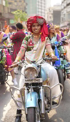 woman in maharastrian traditional outfit riding a motorbike in girgaon gudipadwa shobhayatra 2025
