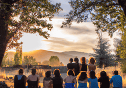 a group of people sitting on a hill