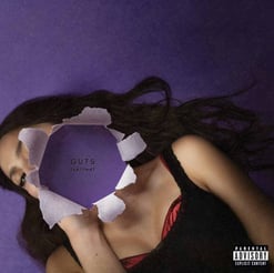 a woman lying on a purple background