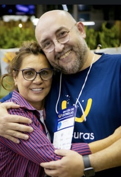 a man and woman are smiling and hugging