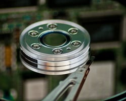 a hard drive disk with a green disk