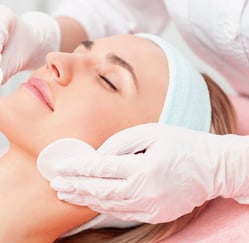 a woman getting a facial lift in a beauty salon