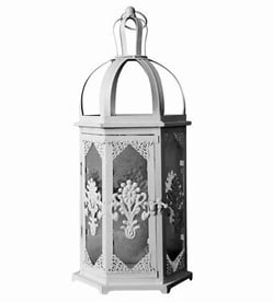 a white lantern with a decorative design on it