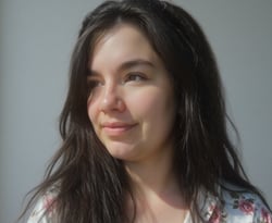a woman with long hair and a flowered shirt
