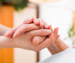 a woman holding hands with her hands clasped in front of her