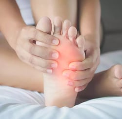 a woman with a painful foot pain