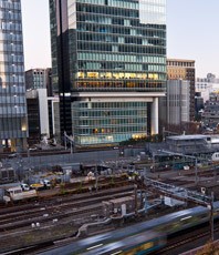 a train traveling through a city with a train passing by
