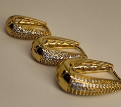 a row of gold - plated earrings with a pair of earrings