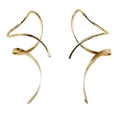 a pair of gold toned earrings with curved curved metal earrings