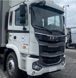 a truck with a trailer parked in a parking lot