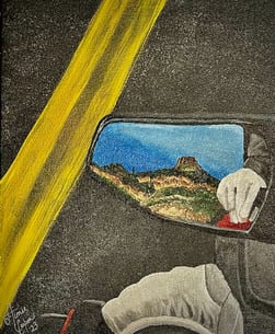 The rearview mirror on a motorcyle ride