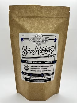 A brown bag with a logo saying White Horse Coffee Blue Ribbon Blend