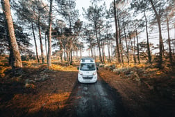 a white car parked on a dirt road