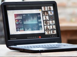 a laptop computer sitting on a table with a cup of coffee