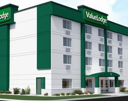 a hotel with a large green sign that says,'welcome to the hotel