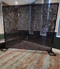 Black shimmer wall setup at the front of a function room for a photo wall in Logan.