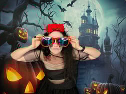 Carly co founder of SweetAz Co. posing in the photo booth for a halloween event in Redlands