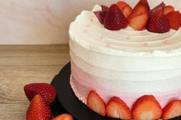 a cake with strawberries and strawberries on a table