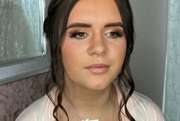 a brunette women having her bridal makeup done