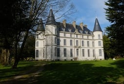 Château de Coat-an-Noz with its elegant turrets and slate roof, a historic castle nestled in the Bre