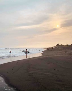 A surfer on the beach of El Paredón, Guatemala.