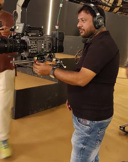 a man in a black shirt is holding a camera and a camera