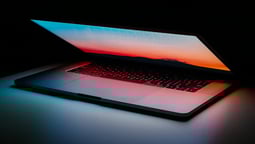 a laptop computer sitting on a table with a laptop