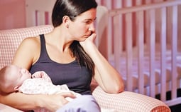 a woman sitting in a chair with a baby