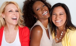 three women are smiling and laughing while posing for a picture