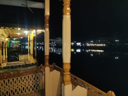 a balcony with a view of a lake and a boat