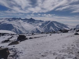 a person standing on a snowy mountain top