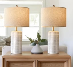 a pair of lamps with a white ceramic table lamp