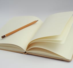 a pencil and pencil on a notebook with a pencil and pencil