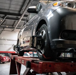 car undergoing wheel balancing and alignment