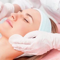 a woman getting a facial lift in a beauty salon