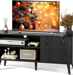 a tv unit with a tv and a shelf