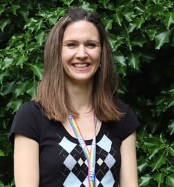a female dementia coach wearing a black shirt and a colourful necklace
