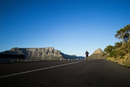 a person riding a skateboard down a hill