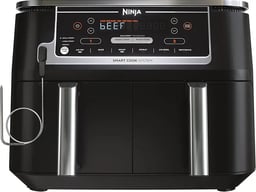 a black and silver air fryer with a knife and a knife in front of