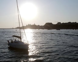 The sailboat Monark sailing on the Douro River at sunset