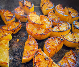 Lemon wedges grilled in a cast iron skillet