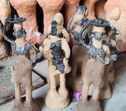 "Handcrafting tribal brass art: Layering fine clay over detailed wax mould in Bastar's Dhokra technique"