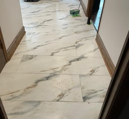 a hallway with a marble floor and a mop
