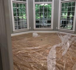 a room with a large window and a chandelier