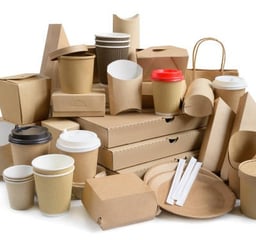 a pile of cardboard boxes with coffee cups and packaging board