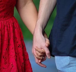 Couple holding hands at a vow renewal
