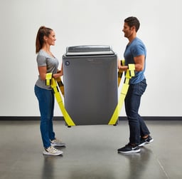 a man and woman from an appliance removal service holding a large washer