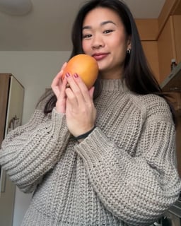 woman holding a mango
