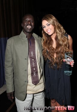 Okello Sam with Global Action Youth Leadership Award Winner Miley Cyrus at the 2011 Global Action Aw