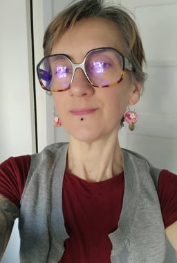 a woman with glasses and a red shirt